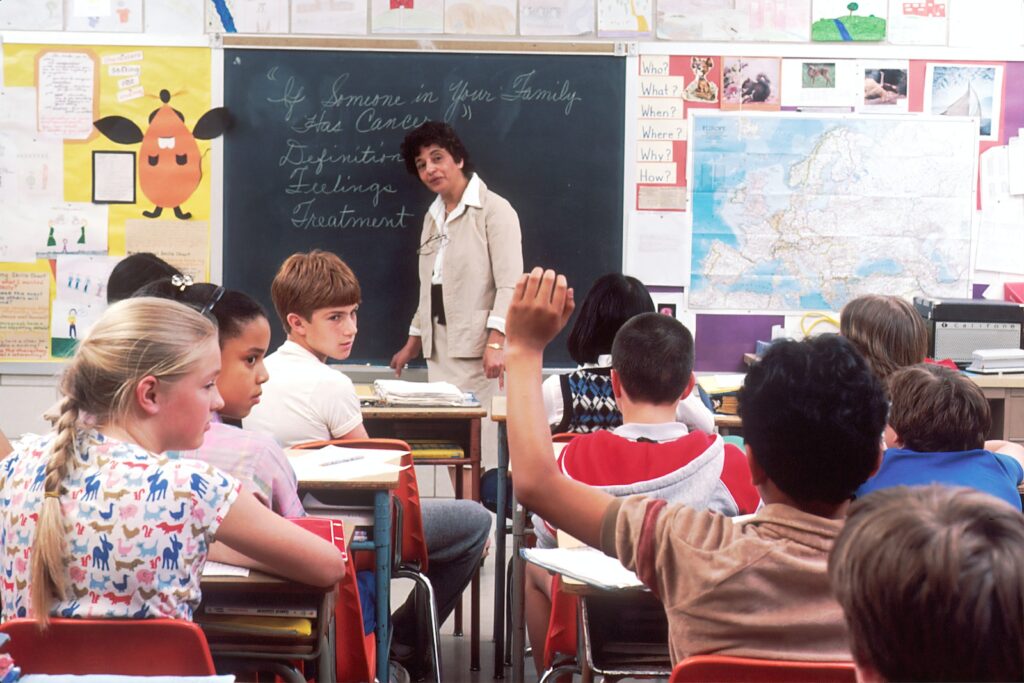 teacher standing in front of children