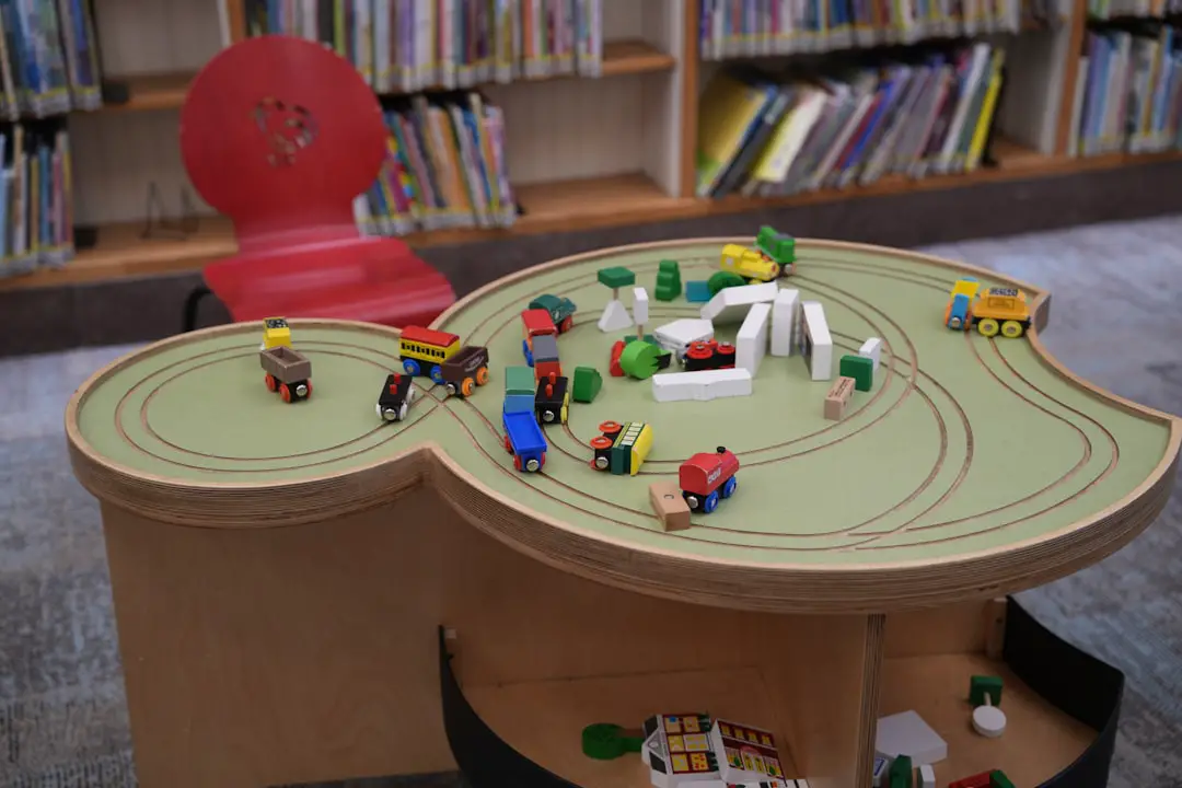 A child's table with a toy train set on it